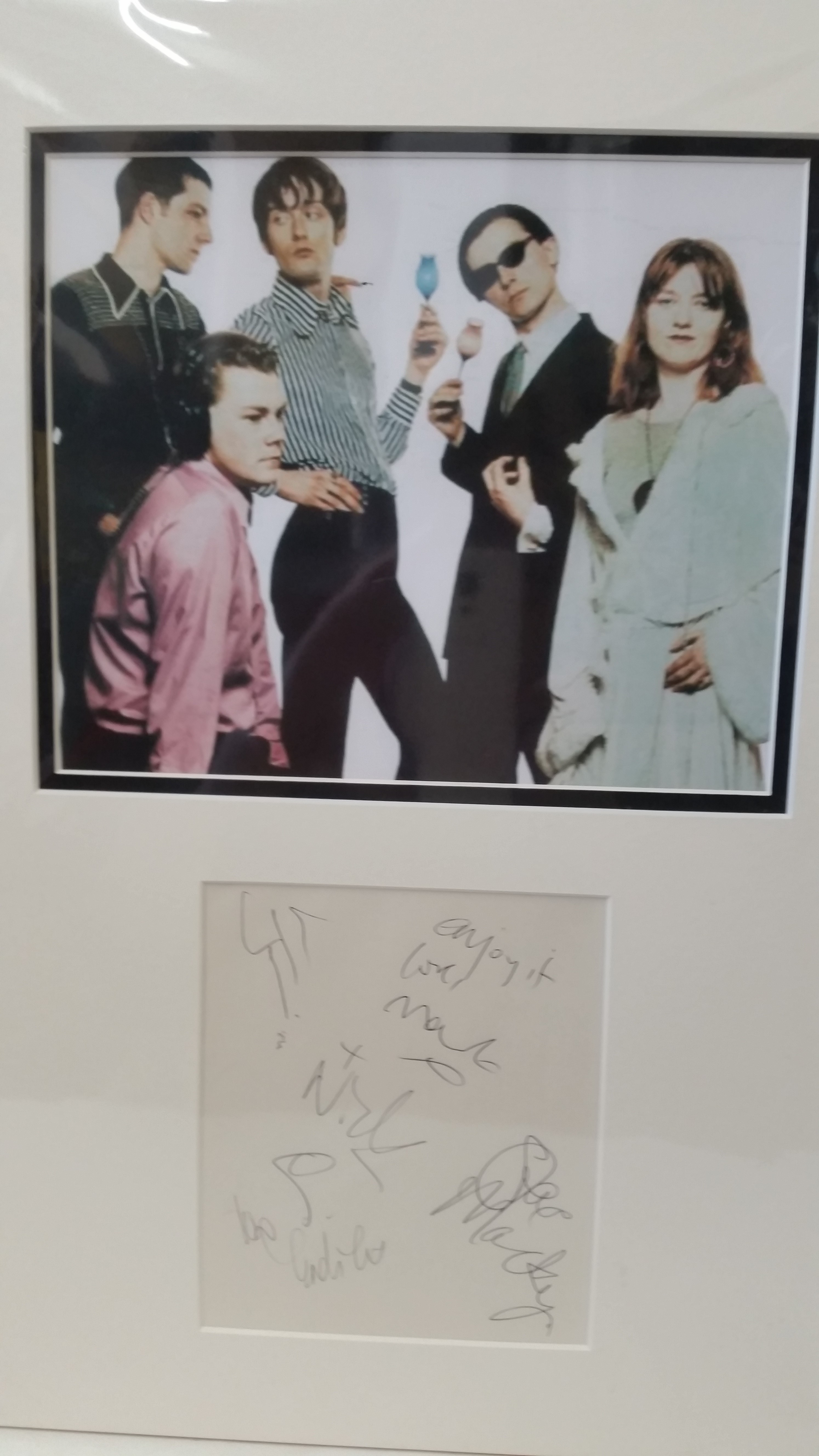 POP MUSIC, signed large page by Pulp, four signatures (first names only), overmounted beneath colour