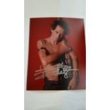 POP MUSIC, signed (in silver felt tip) colour photo, showing Keith Richards topless hugging
