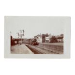 A photographic postcard of a train at Horsham Station, West Sussex, published by The Locomotive