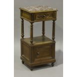 An early 20th century French Louis XVI style walnut bedside cabinet, the rouge marble top above a