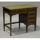 An Edwardian mahogany and satinwood crossbanded desk, the top inset with a gilt-tooled green leather