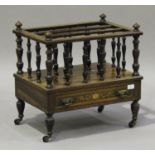 A late Victorian rosewood and foliate inlaid three-division Canterbury, fitted with a drawer, on