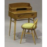 An Ercol elm child's desk, fitted with three drawers, on tapering legs, height 96cm, width 69cm,