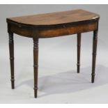 A late George III mahogany fold-over card table with ebony stringing, the top hinged to reveal a
