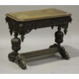 A Victorian oak centre table, profusely carved with masks and scrolls, the canted rectangular top