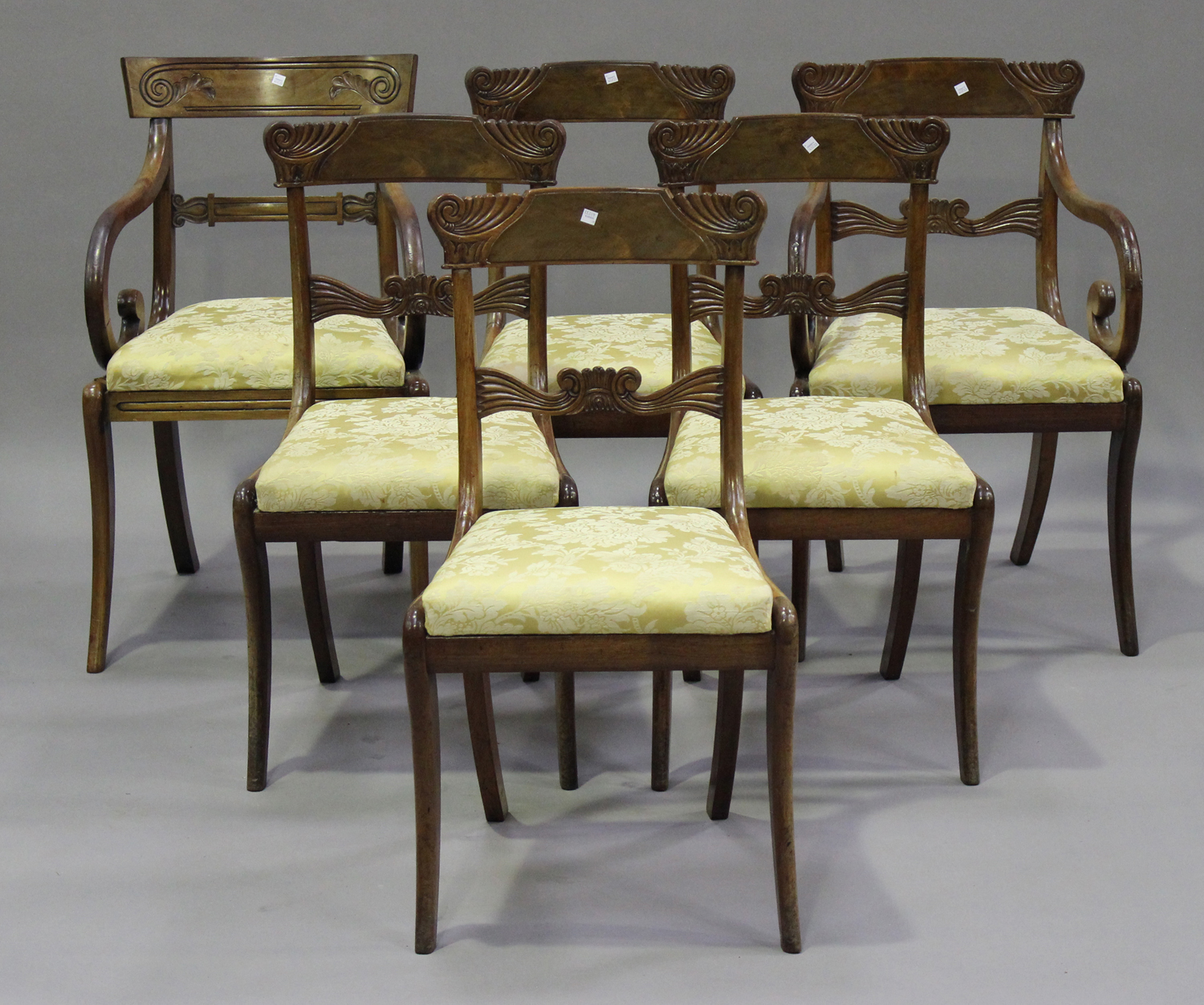 A set of five Regency mahogany bar back dining chairs, comprising one carver and four standards,