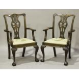 A pair of early 20th century George III style mahogany pierced splat back elbow chairs, the drop-