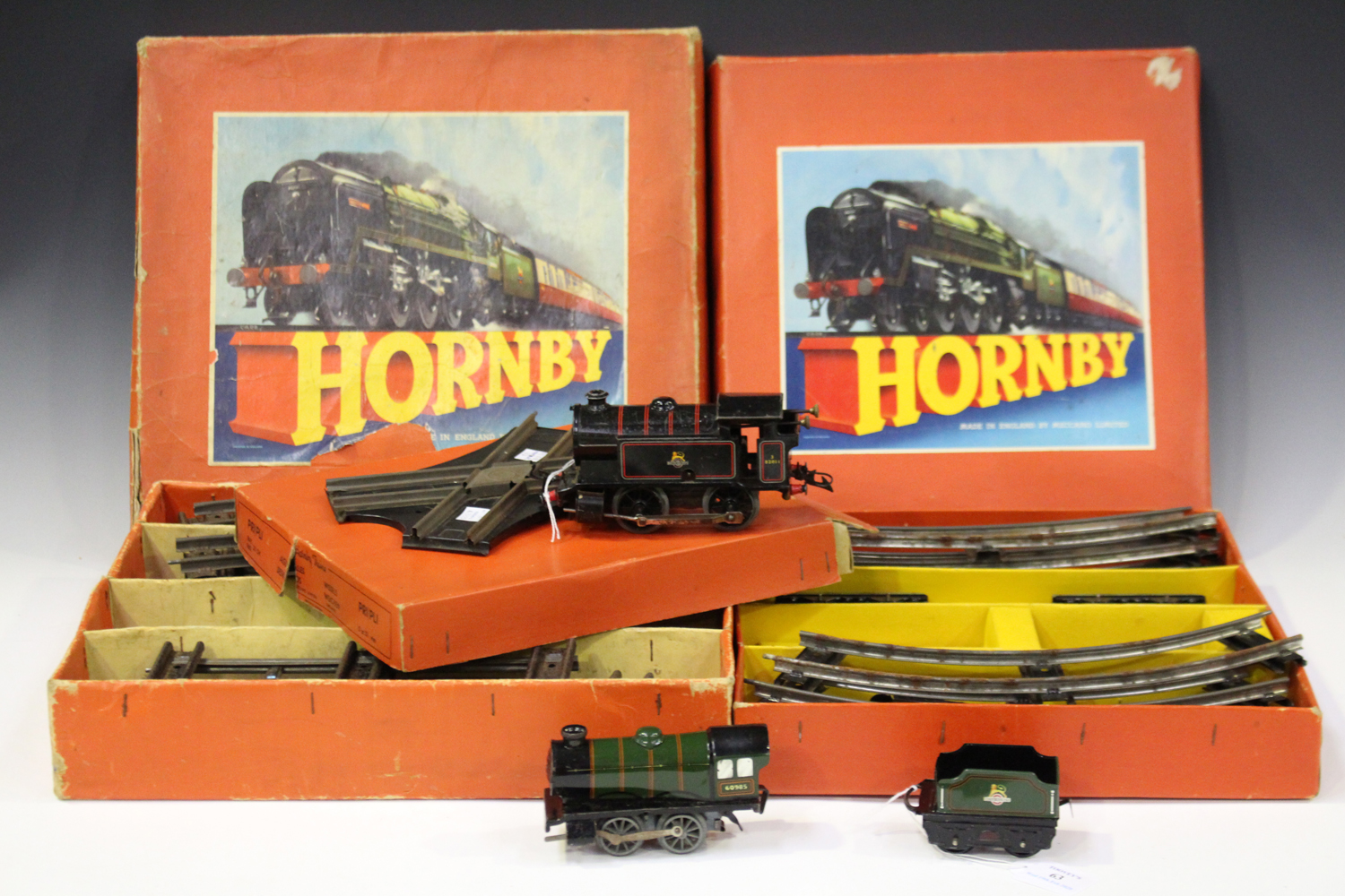 A Hornby gauge O clockwork No. 20 goods train set, a No. 40 part tank goods set and two points,