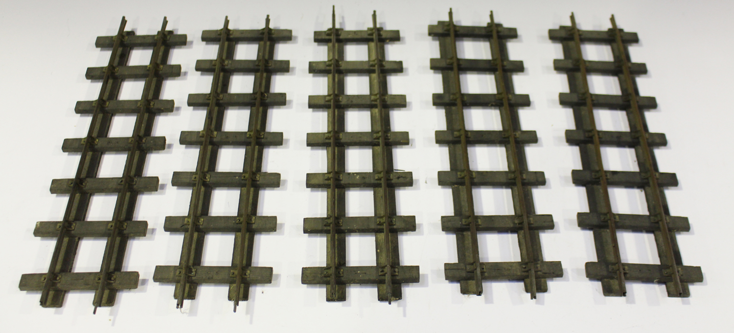 A collection of brass gauge 1 railway track with wooden sleepers, including straights and curves (