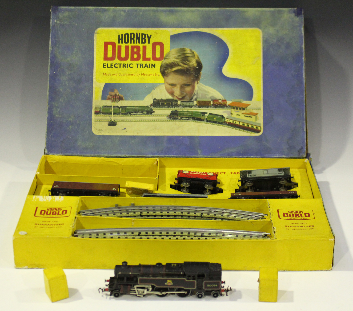 A collection of Hornby Dublo three-rail and two-rail items, including an EDG19 tank goods set, an