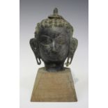 A Thai bronze Buddha head, 18th/19th century, modelled with tightly curled hair rising to a domed