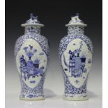A near pair of Chinese blue and white porcelain vases and covers, mark of Kangxi but late 19th