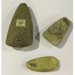 A group of three French Neolithic polished stone axe heads, one bearing 'F.S. Clark Collection'