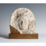 A Greek terracotta antefix, probably 4th century BC, the arched front decorated in high relief