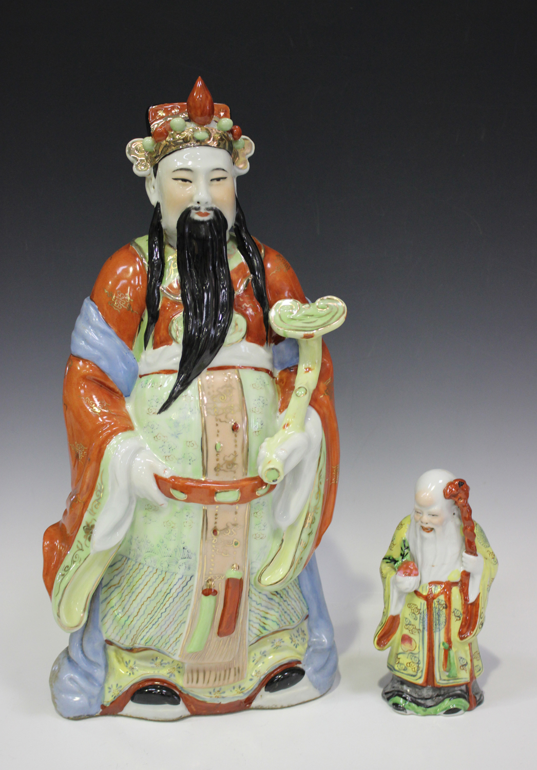 A Chinese porcelain figure of an immortal, mid-20th century, modelled standing wearing a long robe