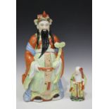 A Chinese porcelain figure of an immortal, mid-20th century, modelled standing wearing a long robe