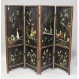 A Chinese hardwood framed and lacquered four-fold screen, Qing dynasty, one side carved in low