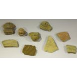 A small group of archaeological pottery fragments, including three pre-Columbian masks.Buyer’s