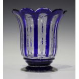 A Bohemian blue flashed glass vase, late 19th century, the faceted, flared cylindrical body engraved