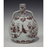 A Chinese Ming style underglaze red porcelain moonflask, probably 20th century, the flattened