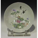 A Chinese famille rose porcelain circular dish, late 19th century, enamelled with two birds