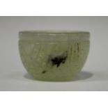 A Chinese small pale celadon jade wine or water cup, Qing dynasty, possibly 18th century, carved