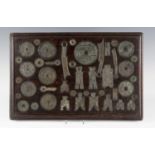 A Chinese bronze inlaid hardwood rectangular panel, 19th century, inset with a collection of forty-