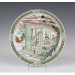 A Chinese famille verte porcelain circular dish, Kangxi period, the interior painted with a scene of