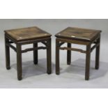 A pair of Chinese hardwood stands, late 19th century, each square panelled top raised on block