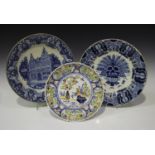 A Makkum delft charger, 20th century in an earlier style, painted in blue with a central urn of