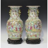 A pair of Chinese Canton famille rose vases, mid to late 19th century, each ovoid body and flared
