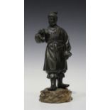 A Japanese brown patinated bronze figure of a woman, Meiji/Taisho period, modelled standing, wearing