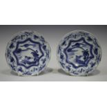 A pair of Chinese blue and white Kraak porcelain saucer dishes, late Ming dynasty, probably Wanli