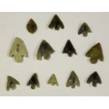 A group of twelve British Bronze Age chipped flint arrowheads of barbed, tanged and leaf design,