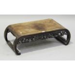 A Chinese hardwood low table, late 19th/early 20th century, the rectangular panelled top with curved