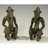 A pair of African carved and stained wooden male and female figures, probably Senufo, Ivory Coast,