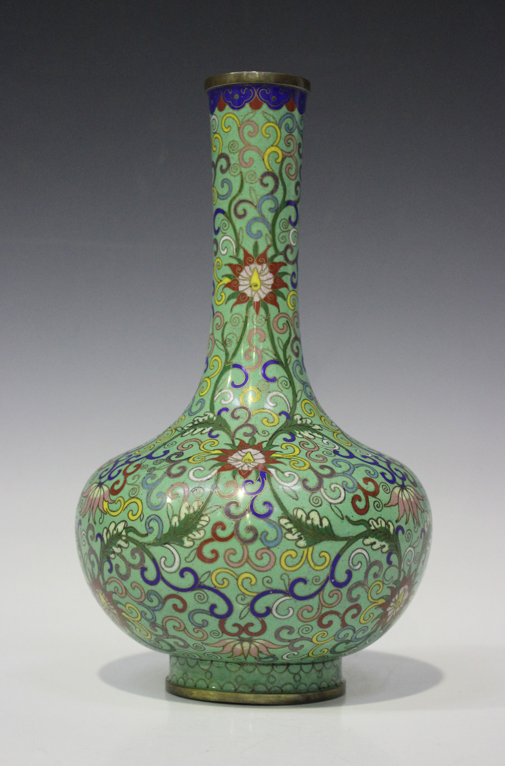 A Chinese cloisonné pale green ground bottle vase, early 20th century, the bulbous body with