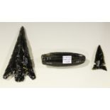 A group of three American obsidian artefacts, comprising a core and two arrowheads, one
