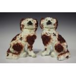 A pair of porcelaneous Staffordshire models of spaniels, early 19th century, with iron red