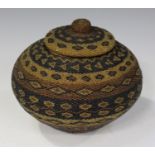 An African beadwork jar and cover, decorated with overall horizontal bands of geometric forms,