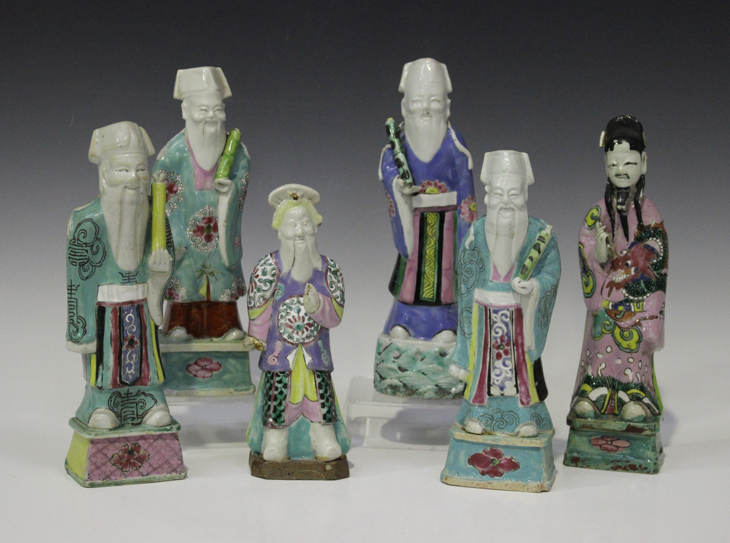 A group of six Chinese famille rose enamelled biscuit porcelain figures of immortals, 18th