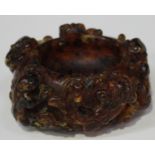 A Chinese reconstituted amber brushwasher, probably late Qing dynasty, the exterior carved in relief