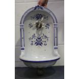 A French Herbeau faience niche water fountain, 20th century, the arched back painted in shades of