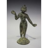 An Indian bronze figure of a deity, modelled standing on a domed lotus base, height 18cm.Buyer’s