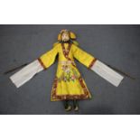 A Chinese puppet of Mr Wu, early 20th century, wearing a yellow silk costume, height 68cm.Buyer’s