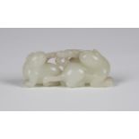 A Chinese pale celadon jade carving, Qing dynasty, probably 18th century, attractively modelled as