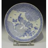 A Japanese Arita blue and white porcelain circular charger, Meiji period, painted with a peacock