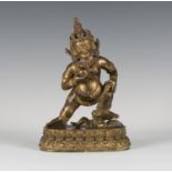 A Sino-Tibetan gilt bronze figure of Jambhala, probably Qing dynasty, the god of wealth modelled