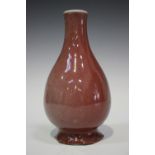 A Chinese sang-de-boeuf glazed porcelain bottle vase, Qing dynasty, of ovoid form with narrow