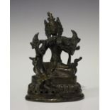 A Sino-Tibetan brown patinated bronze figure of Tara, probably early 20th century, modelled seated